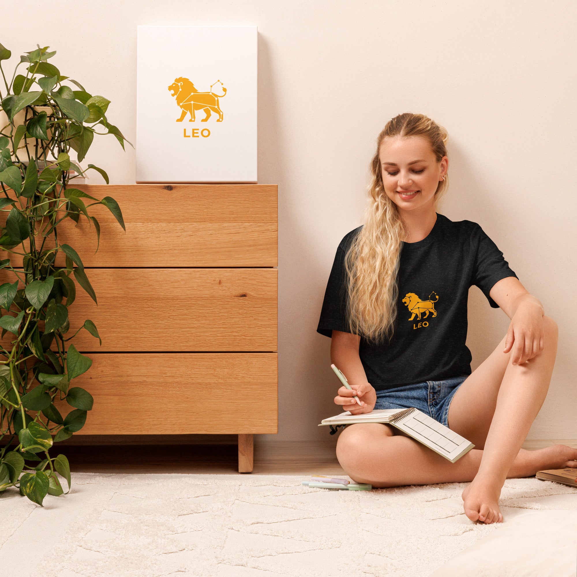 Leo Rising tee: gold lion icon with white constellation lines on a unisex t-shirt