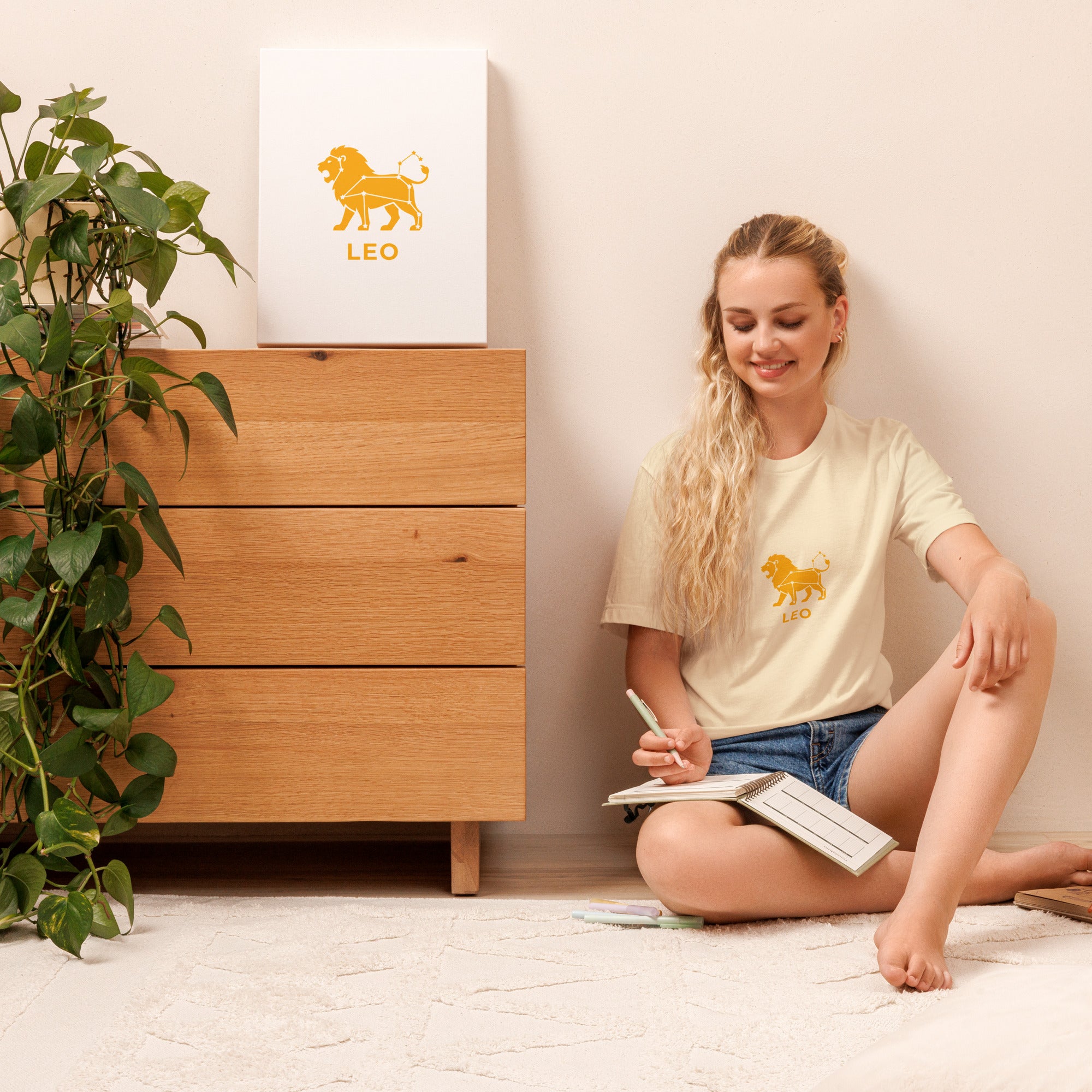 Leo Rising tee: gold lion icon with white constellation lines on a unisex t-shirt