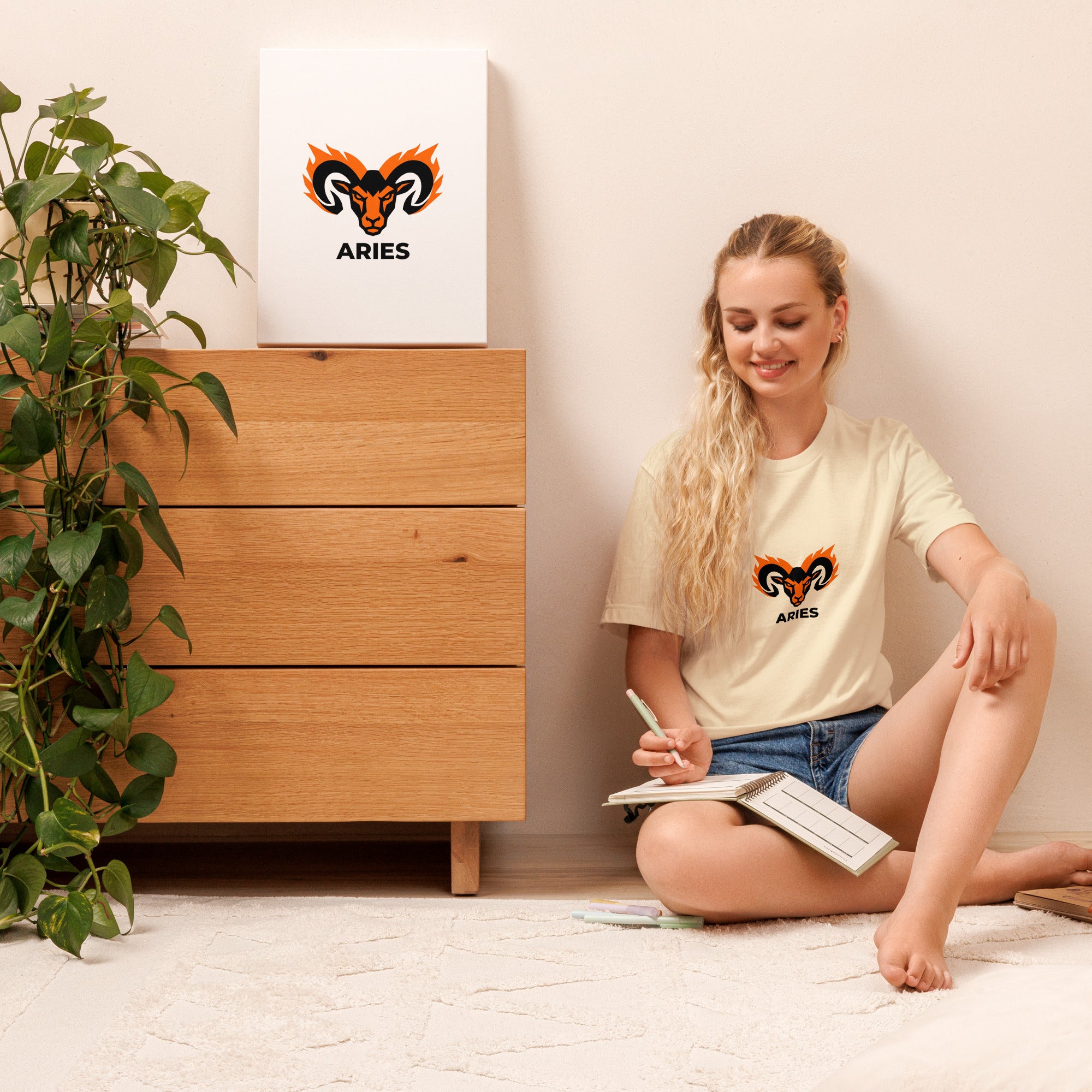 Blaze Ram tee: flaming ram horns in black and orange on a unisex Aries t-shirt