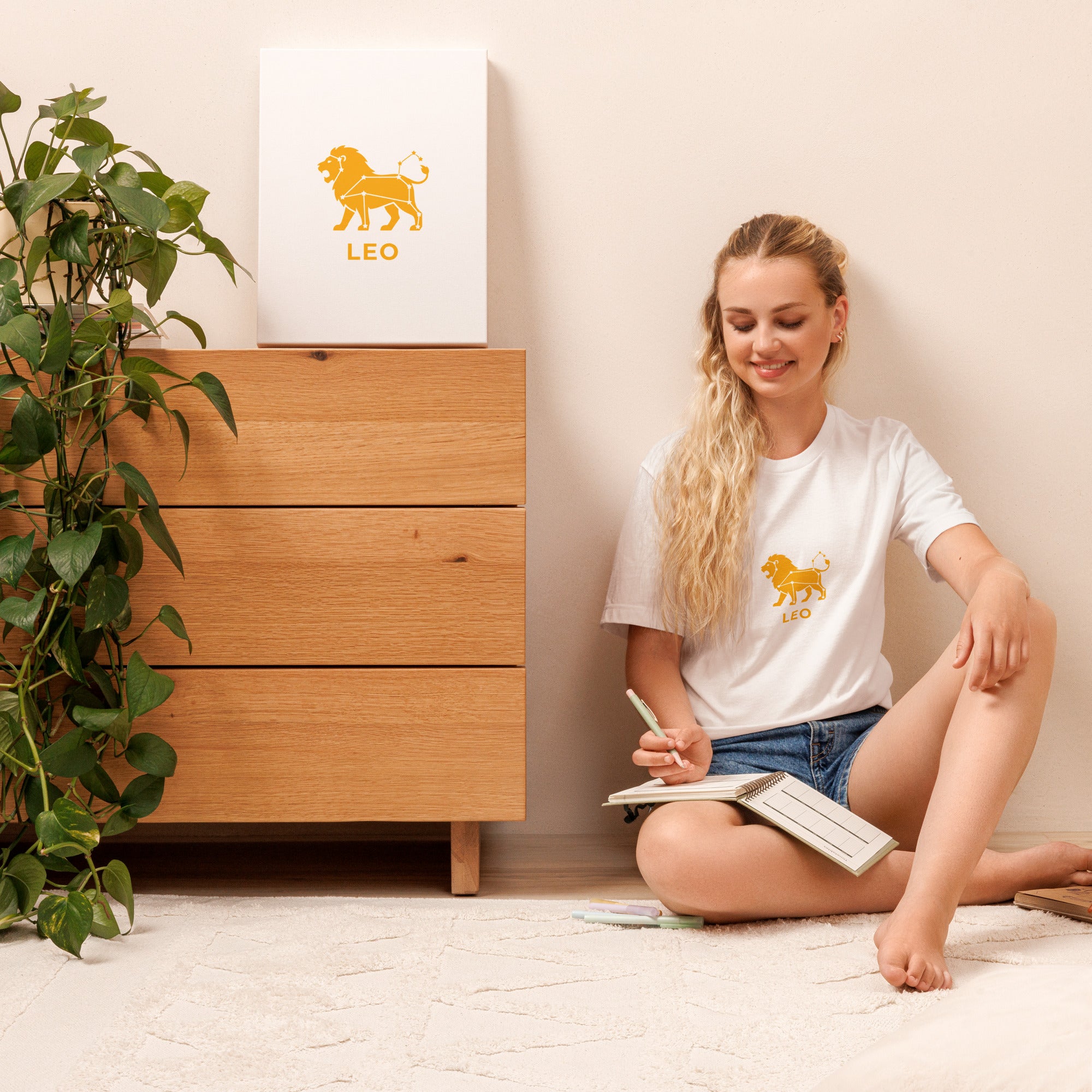 Leo Rising tee: gold lion icon with white constellation lines on a unisex t-shirt